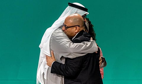 Sultan Al Jaber, COP28 President and Simon Stiell, UNFCCC Executive Secretary, hug each other at the end of the event. Photo: @COP28_UAE / X