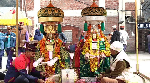Two Hindu priests chant prayers before idols of deities. Photo provided by Rohit Prashar