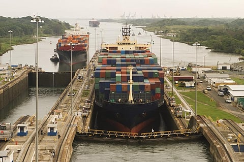Freight ships, assisted by tugboats, entering the Panama Canal at Gatun Locks on the Atlantic side, headed west towards the Pacific. The Canal has recently recorded diminished water levels due to climate change. Photo: iStock