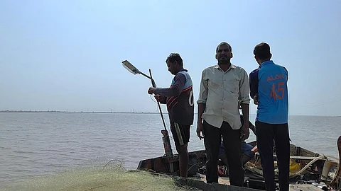 Fisherfolk are abandoning their traditional occupation due to the reduced flow of water in the Narmada and the depletion of fish stock. One such person is Kalpeshbhai (in middle)