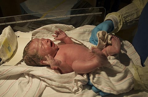 Delivering a human baby – which has a large, highly developed brain – is risky for mother and baby. jaredandmelanie/flickr , CC BY