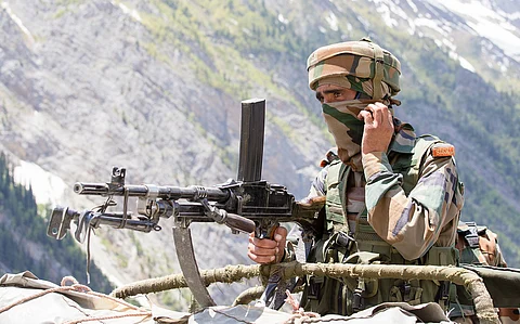 An Indian Army soldier stands guard in Kashmir.