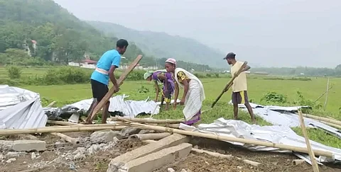 Lokhu Gowala among the ruins of his house near the Kaziranga National Park.
