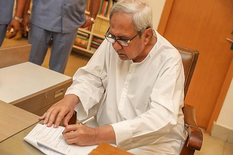 Odisha CM Naveen Patnaik puts in his signature for the immediate disbursal of assistance to farmers of Odisha under the KALIA scheme in 2019.