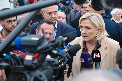 Marine Le Pen speaking to the press at a conference