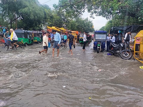 People walking on flooded streets of Sangam Vihar