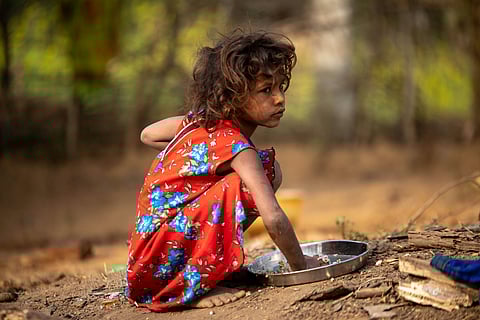 A child eating food in a tribal area of Jharkhand.