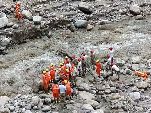 Rescue and relief workers engaged in rescue and relief work after heavy floods in Samej Khad in Rampur area of Shimla district.