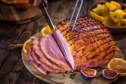 Topview of a plate of ham being carved
