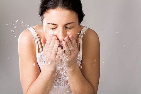 Woman washing her face