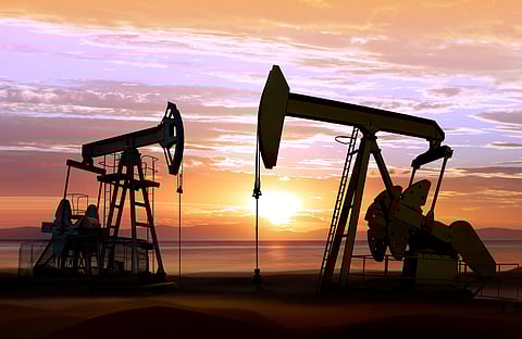 Silhouette of working oil pumps on sunset background
