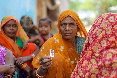 Basanti Gond showing a photograph of her husband Munni Lal, who died recently.