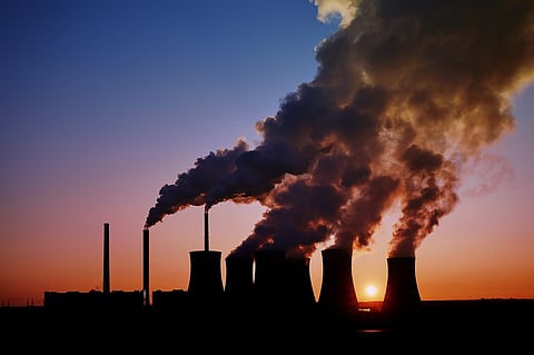 Coal fired power station silhouette at sunset