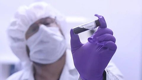 Project scientist Jason Dworkin holds up a vial that contains part of the sample from asteroid Bennu delivered to Earth by NASA’s OSIRIS-REx mission in 2023.
