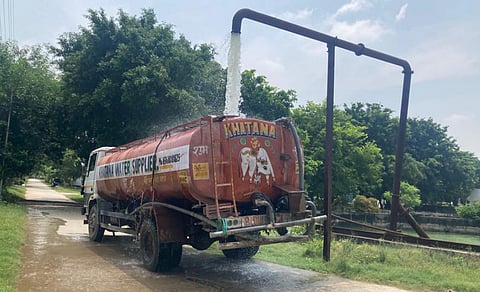 A tanker getting filled with treated wastewater for reuse in construction activities from hydrant located inside Behrampur STP.