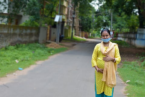 Indian pregnant woman standing on the street