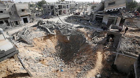 An aerial view of the heavily damaged and collapsed buildings in Gaza city, taken 25 October, 2023