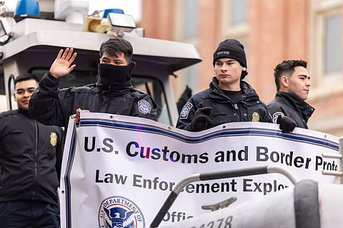 Members of the US Customs and Border protection riding a boat in an 2022 parade.