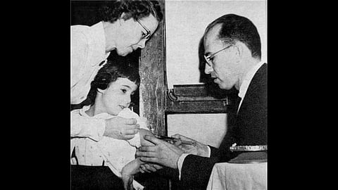 Magazine photo of Jonas Salk in laboratory.
