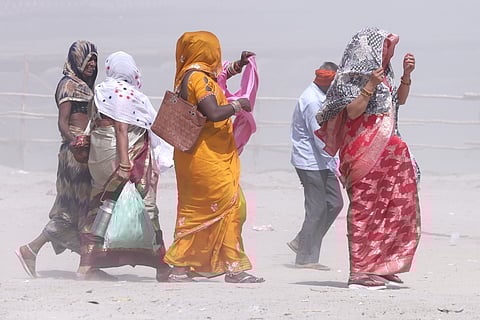 Indian people brave heat wave conditions during a hot summer day at the banks of Sangam in Prayargaj , India