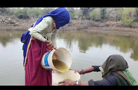 Women of Raika Mala spend several hours every day fetching water from the green, murky johad.