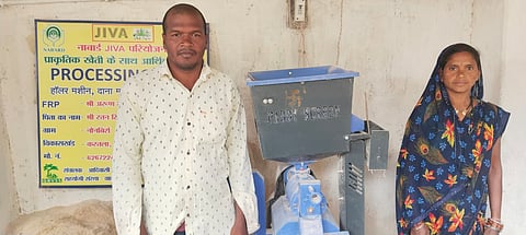 Arun Singh Rathia and his wife Basanti Rathia with the paddy dehuller machine that has transformed their village.