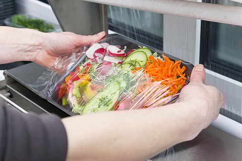 Salad being wrapped in plastic. Photo: iStock