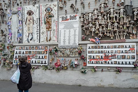 A woman looking "The Wall of Dolls", a public art installation exhibit in Ticinese district in Milan, Italy to help shine a light on the increasing violence against women throughout the world. Photo: iStock