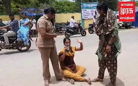 கணவரை தாக்கிய காவலர்கள்... தர்ணாவில் ஈடுபட்ட மனைவி!!