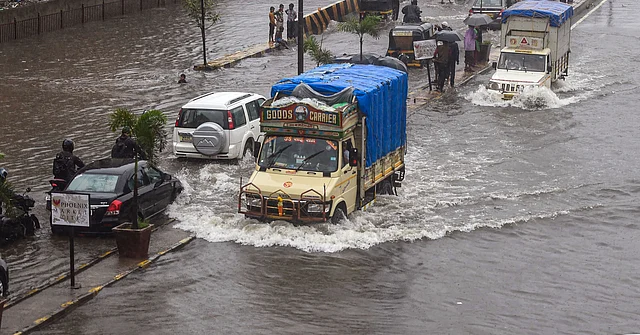 मुंबई के घाटकोपर में जल भरी सड़कों से निकलने के लिए मजबूर वाहन
