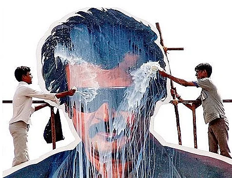 Fans pour milk on a Rajinikanth cut-out.