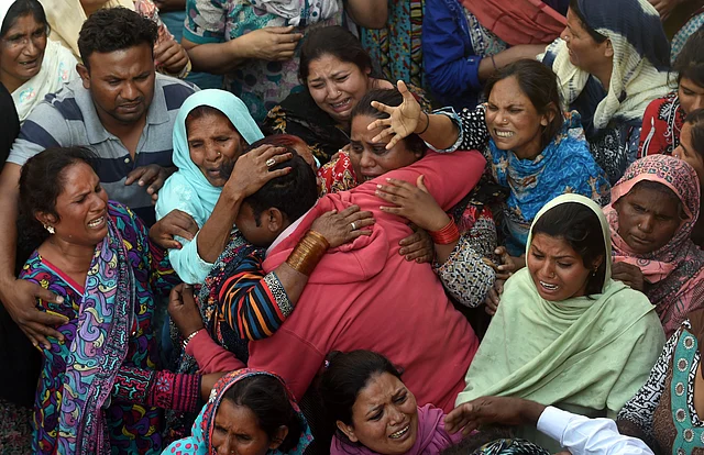 Pakistani Christians mourn as they attend a funeral for a blast victim of the March 27 suicide bombing, in Lahore on March 28, 2016. Pakistan’s army launched raids and arrested suspects after a Taliban suicide bomber targeting Christians over Easter killed 72 people including many children in a park crowded with families. / AFP / ARIF ALI (Photo credit: ARIF ALI/AFP/Getty Images)