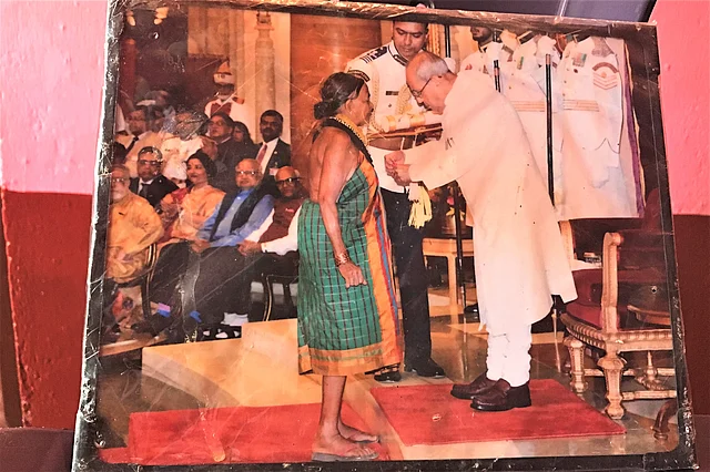The laminated picture of her Padma award wrapped in plastic.