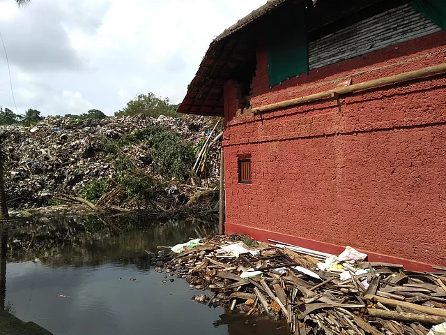 Trash and storm water surrounding Mandara Keshav Bhat’s house.