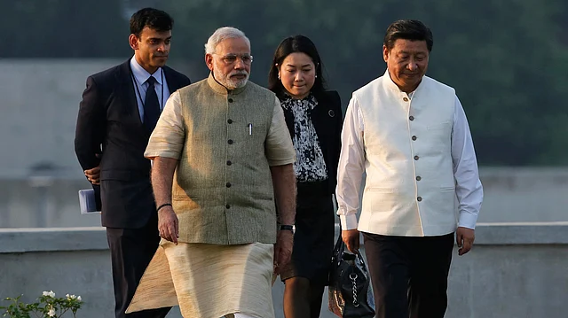 India needs to act cautiously on the AIIB initiative as China has been accused of economic coercion in the past. China’s President Xi Jinping with PM Modi in Ahmedabad, September, 2014 (Courtesy: Reuters)