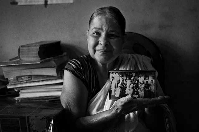 Shukla Roy with the family photograph. The little girl in the saree on the extreme left is Shukla. (Photo: Smita Sharma)