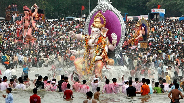 Devotees carry idols of Lord Ganesha, the Hindu deity of prosperity, for immersion in the Arabian Sea in Mumbai.
