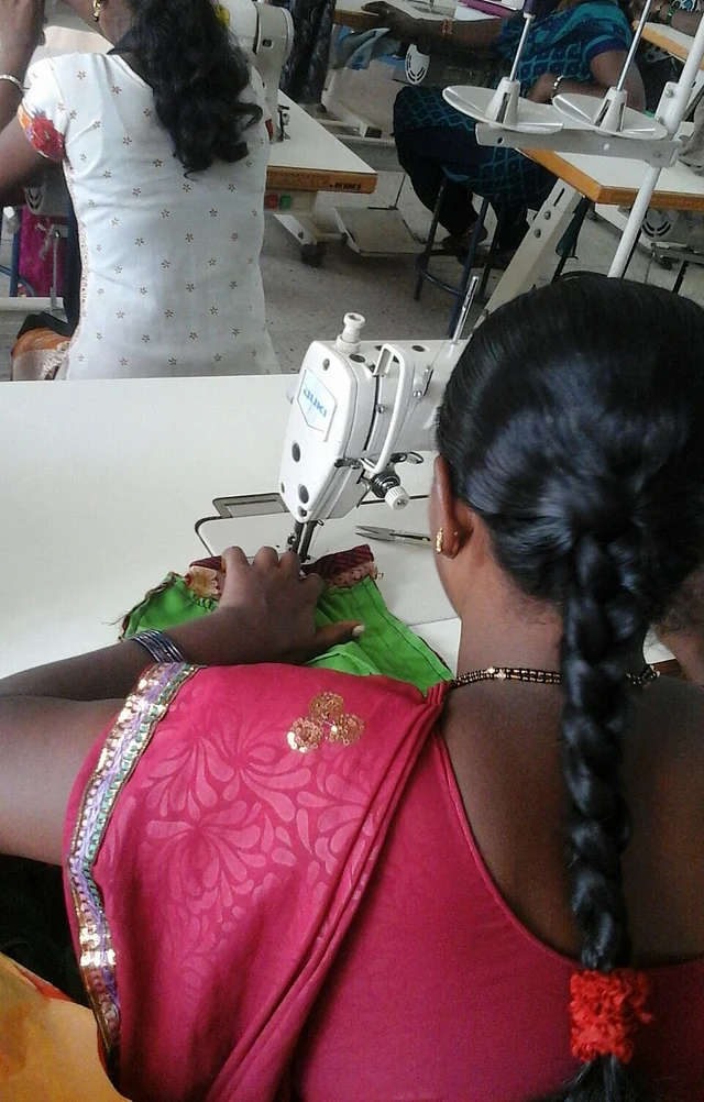A woman hard at work, sewing the threads of her freedom. (Photo Courtesy: Threads of Freedom)