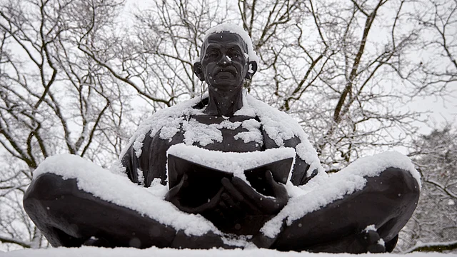 Snow falls on a statue of Mahatma Gandhi on a winter morning in Geneva. (Photo: Reuters)