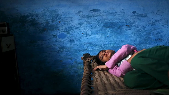 Sajida Saifi, daughter of Akhalaq Saifi, who was killed by a mob, mourns his death inside her house at Bisahara village in Uttar Pradesh. (Photo: Reuters)