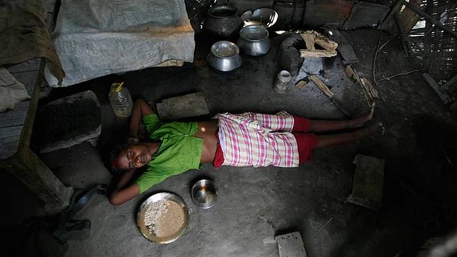 A tea garden worker suffering from malnutrition lies inside her damaged house in the closed Bharno Bari tea garden estate, about 115 km from Siliguri, West Bengal. (File photo: Reuters)