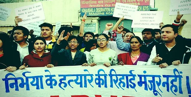 Activists along with Nirbhaya’s mother (second from left) staging a protest against the release of juvenile delinquent in the Nirbhaya case, in New Delhi on Saturday. (Photo: PTI/Altered by <b>The Quint</b>)