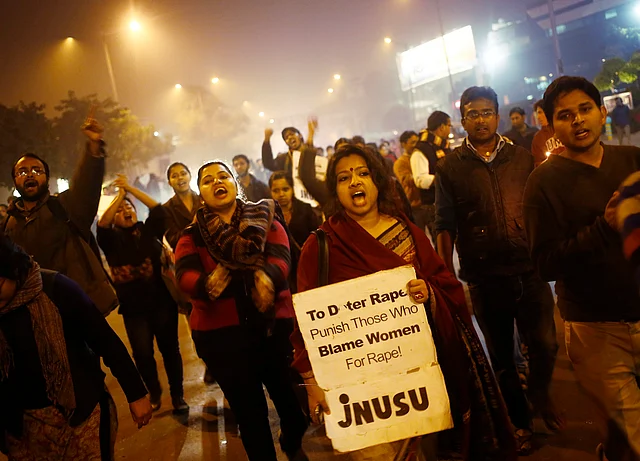 Demonstrators shout slogans during a candlelight vigil to mark the first anniversary of Delhi gang rape, in New Delhi December 16, 2013. (Photo: Reuters)