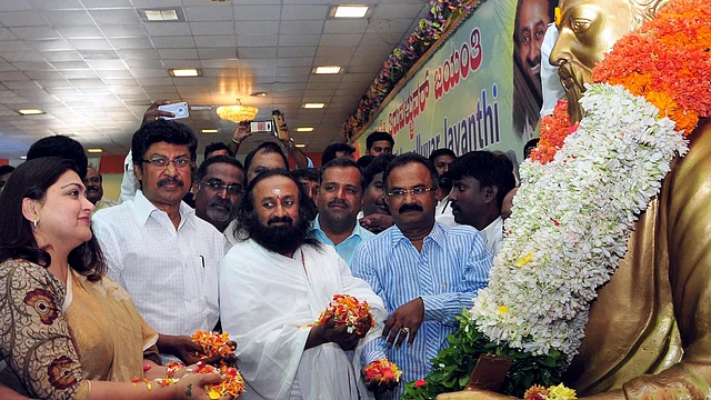 Sri Sri Ravi Shankar has a long list of awards and honorariums including a Padma Vibhushan behind him (Photo: PTI)