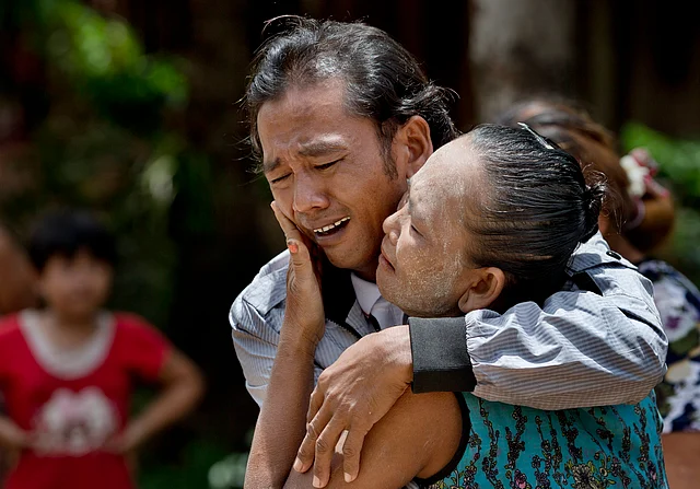 In this 16 May 2015 file photo, former slave fisherman Myint Naing and his mother, Khin Than, cry as they are reunited after 22 years at their village in Mon State, Myanmar. (Photo: AP)