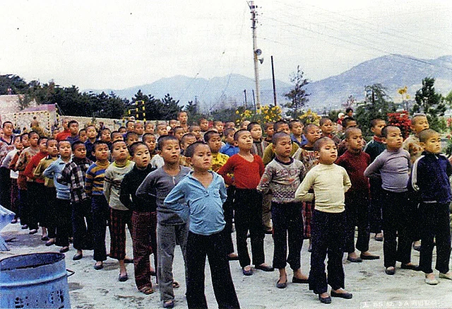 In this undated image provided by the Committee Against Institutionalizing Disabled Persons, a civic group representing the former inmates, child inmates line up for morning assembly at the Brothers Home in Busan, South Korea. (Photo: AP)