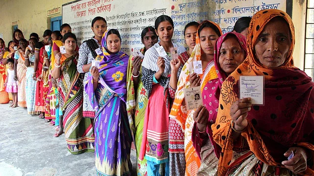 Women show their voter’s identity card as they queue up to cast their
votes during the second phase of West Bengal Legislative Assembly polls
in South Dinajpur, April 17, 2016. (Photo: IANS)