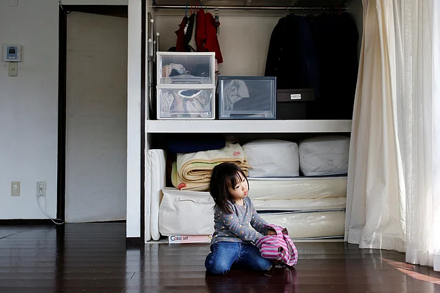 Two-and-a-half year old Ei, the daughter of minimalist Naoki Numahata, sits in the family living-room in Tokyo. (Photo: Reuters) 