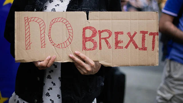 A woman holds a poster during a protest in Berlin, opposing Britain’s exit from the European Union. (Photo: AP)