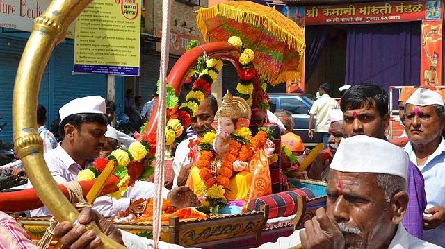 Devotees carry an idol of lord Ganesha for installation at a pandal on the occasion of Ganeshotsav. 